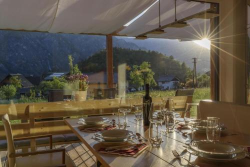 a table with glasses and a bottle of wine on it at Ferienlodge MaResi in Bad Goisern