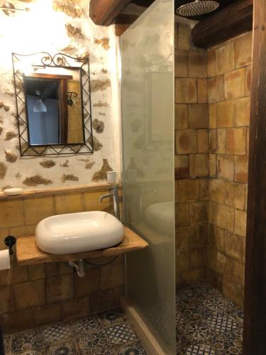 a bathroom with a sink and a mirror and a tub at agriturismo roba degli ulivi in Agrigento