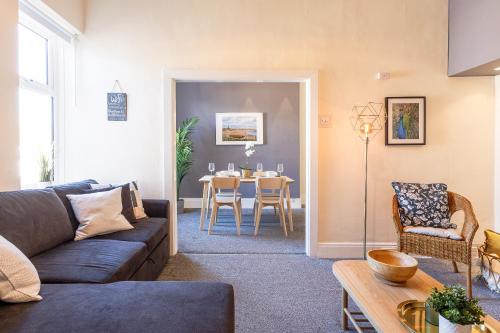 a living room with a couch and a table at Cozy Coastal Getaway in North Shields