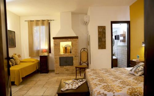 a hotel room with a bed and a fireplace at B&B Sabir in San Vito lo Capo