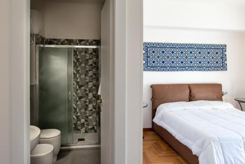 a bedroom with a bed and a shower at ARMONIE Salesiani Lecce in Lecce