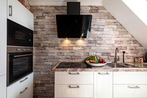 a kitchen with a sink and a microwave at Landhaus Wremer Deel in Wremen