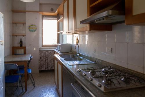 a kitchen with a sink and a stove top oven at ARMONIE Salesiani Lecce in Lecce