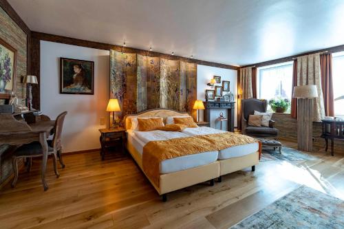a bedroom with a bed and a table and a desk at Landhaus Wremer Deel in Wremen