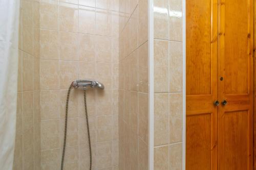 a shower with a hose in a bathroom at Filippi in Son Parc