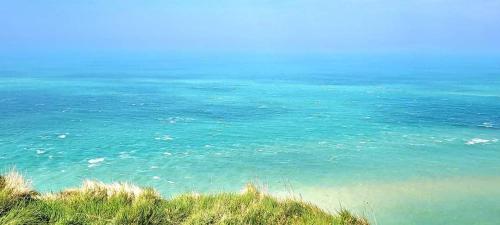 a view of the ocean from a bluff at La Nouvelle Criqueboise in Criquebeuf-en-Caux