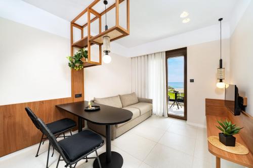 a living room with a table and a couch at Acantha Suites in Skala Potamias