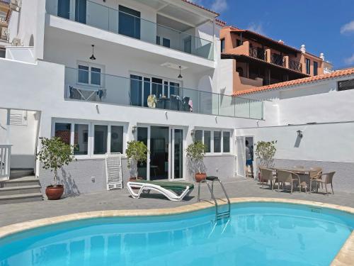 a swimming pool in front of a house at Adeje Deluxe Villas Santa Monica in Adeje