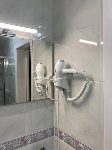 a bathroom with a blow dryer on the wall at Casa da Rocha - Alojamento Local in Vila Nova de Foz Coa