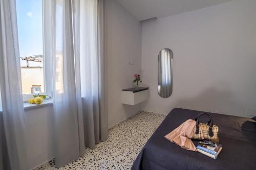 a bedroom with a bed and a window at Neva Suites Massa Lubrense Sorrento Coast in Massa Lubrense