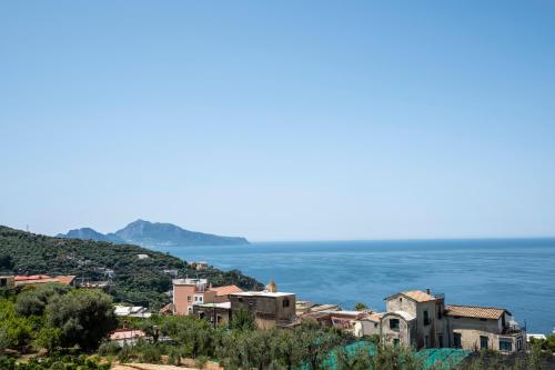 a town on a hill overlooking the ocean at Neva Suites Massa Lubrense Sorrento Coast in Massa Lubrense