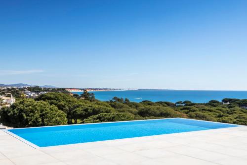 a swimming pool with a view of the ocean at Vila Maria Hotel - Adults Only in Albufeira