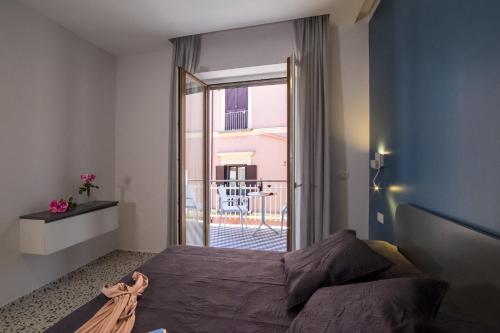 a bedroom with a bed and a large window at Neva Suites Massa Lubrense Sorrento Coast in Massa Lubrense
