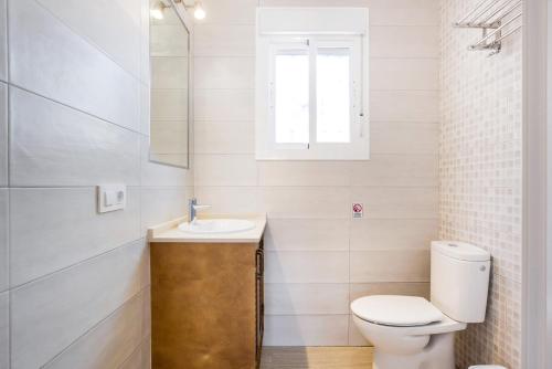 a bathroom with a toilet and a sink at Casa Torre de Meca 1 Shared Pool in Los Caños de Meca