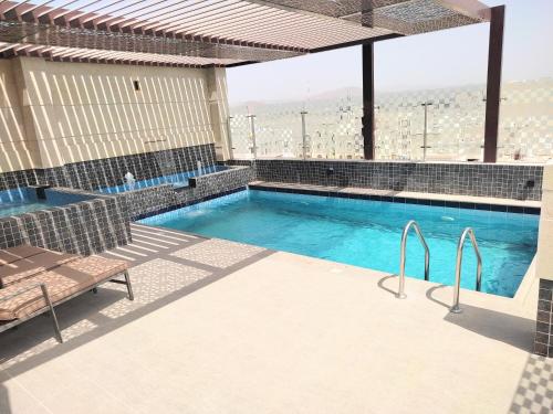 a swimming pool with a view of a building at Nizwa Inn - نزوى إن in Nizwa