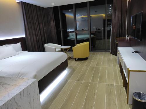a hotel room with a bed and a desk at Nizwa Inn - نزوى إن in Nizwa