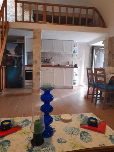 a kitchen with a table with a blue vase on it at Stonehouse in Mani Penisula in Koíta