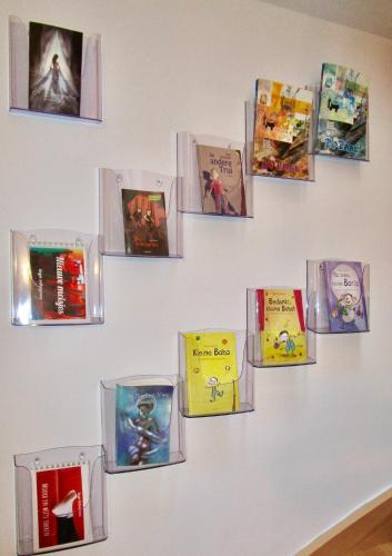 a wall with many books on a wall at Le Relais des Fagnes in Sart-lez-Spa