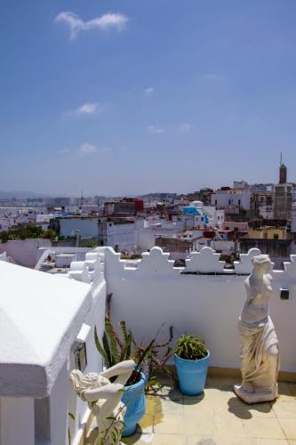 a balcony with a view of a city at Dar Tinjâa in Tangier