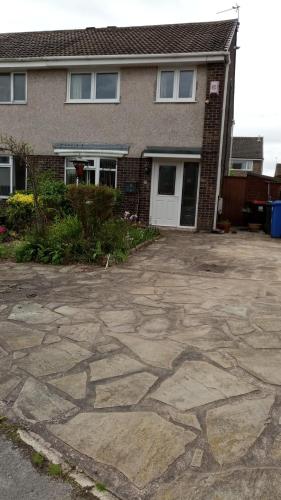 a house with a stone driveway in front of it at Beeston House in Thornton