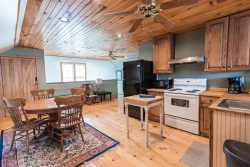 a kitchen and dining room with a table and chairs at The Loft at the Barn in Bolivar