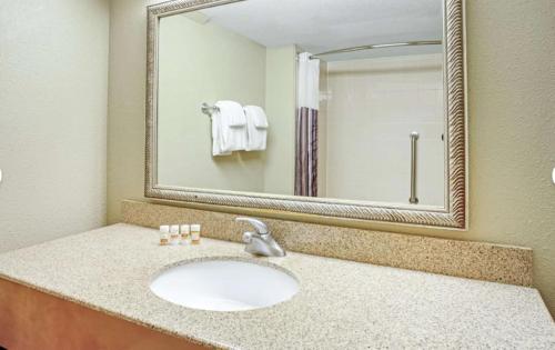 a bathroom with a sink and a mirror at La Quinta by Wyndham Minneapolis-Minnetonka in Minnetonka