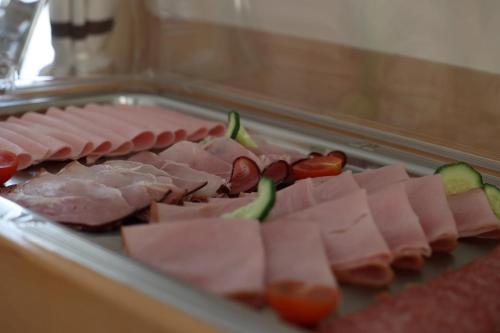 a bunch of meats and vegetables on a table at Hotel "Wilder Mann" in Linz