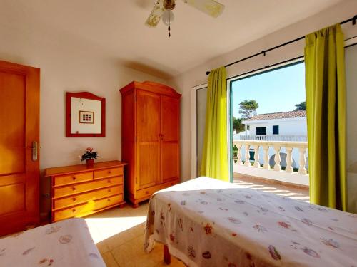a bedroom with a bed and a large window at Villa Limón in Cala Blanca