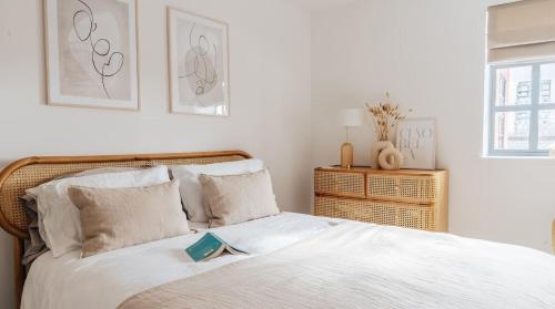 a bedroom with a bed with a book on it at BRAND NEW apartment - Stay in the heart of the city in Norwich