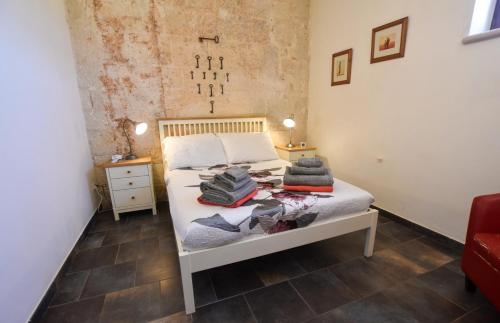 a bedroom with a bed with towels on it at Masseria Giulio in Francavilla Fontana