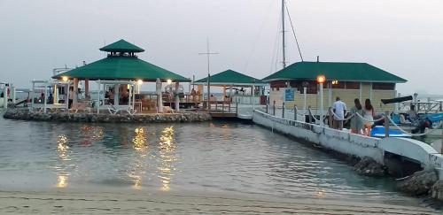 a group of people at a dock with a restaurant at Parco del Caribe in Boca Chica