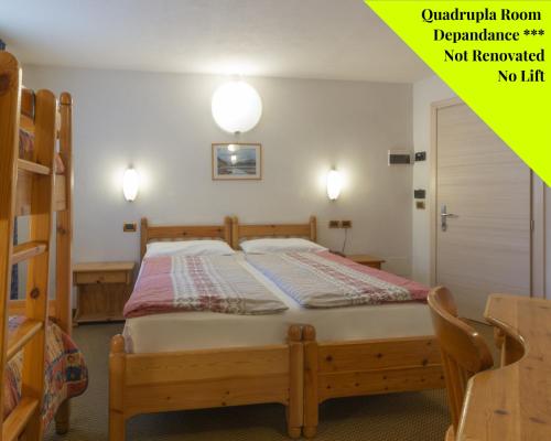 a bedroom with a bed in a room at Alpen Resort Bivio in Livigno