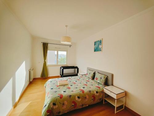 a bedroom with a bed and a window at Sunny Home Lisboa Expo, free parking in Lisbon