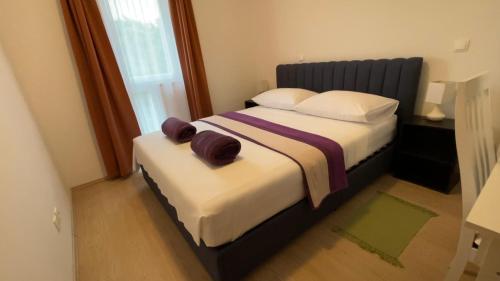 a bed room with a white bedspread and a white comforter at Villa Evita Apartments in Maranovići
