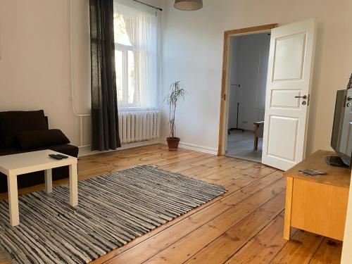 a living room with a couch and a table at Spacious Ausekla apartment in Liepāja