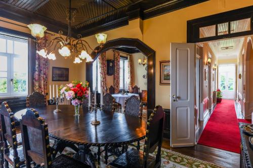 a dining room with a table and a mirror at Quinta Lusitânia in Santa Comba Dão