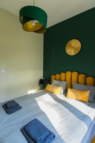 a bedroom with a large bed with blue towels on it at Pasjonat Tu in Tuczno