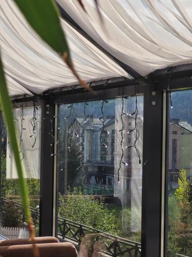 a window with a view of a building at Zaporizʹka Sich in Bukovel