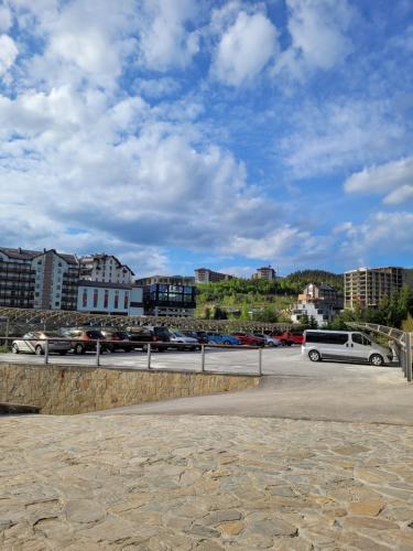 a parking lot with cars and buildings in a city at Zaporizʹka Sich in Bukovel