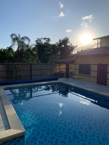 a swimming pool in front of a house at Pousada Portal do Cerrado in Pirenópolis