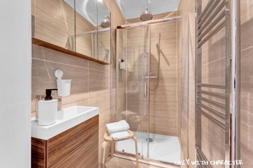 a bathroom with a shower and a sink at Cozy with Character Cochrane Cottage at Leith Links Park in Edinburgh