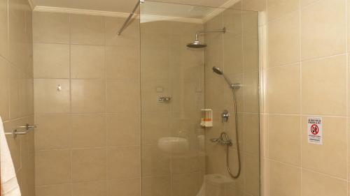 a shower with a glass door in a bathroom at Tantakuy Eco Experience Hotel in La Huaica