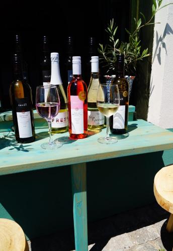 a table with wine bottles and wine glasses on it at Olivea penzion & wine Mikulov in Mikulov