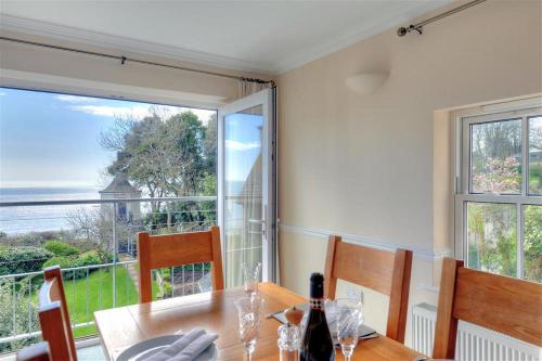 a dining room with a table and a large window at The Portland Suite in Lyme Regis