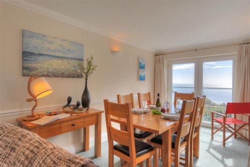 a dining room with a table and chairs and a dining room at The Portland Suite in Lyme Regis