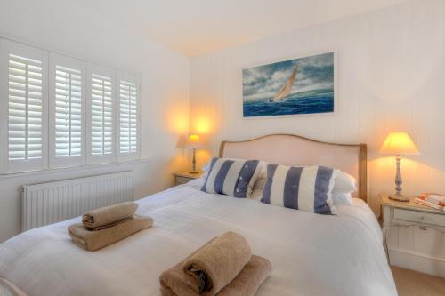 a bedroom with a bed with towels on it at Starfish in Lyme Regis
