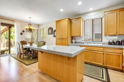 a kitchen with wooden cabinets and a large counter top at Wine Country Hideaway in Windsor