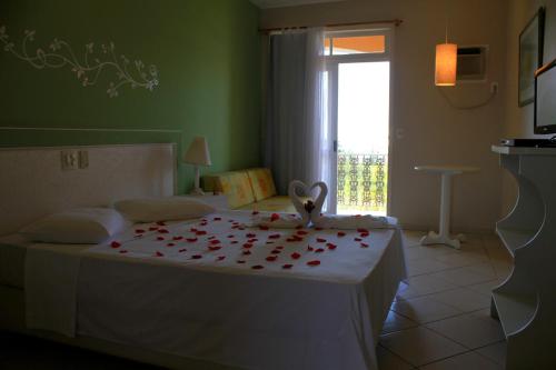 Tempat tidur dalam kamar di Hotel Porto de Paz - Shantiniketan