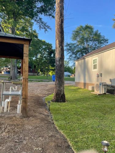 a picnic shelter next to a tree next to a building at Cozy Cabin in Crestwood Subdivision in Avinger