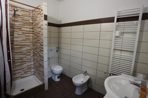 a bathroom with a toilet and a sink and a shower at Al Seminario in Tivoli